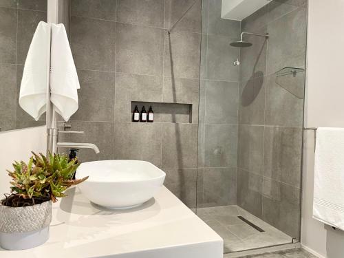 a bathroom with a sink and a shower at Hilltop 39, Oubaai Golf Estate in Herolds Bay