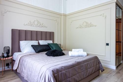 a bedroom with a large bed with two pillows on it at Resto Park Традиція in Podvorki