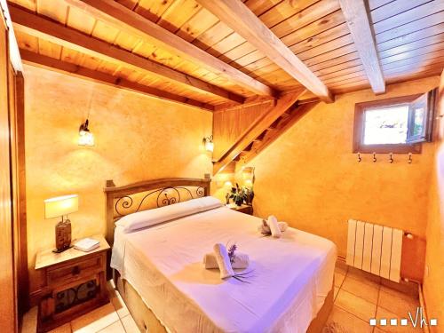 a bedroom with a large bed with white sheets and a window at VH CostaBlanca - CALIMA in Benissa