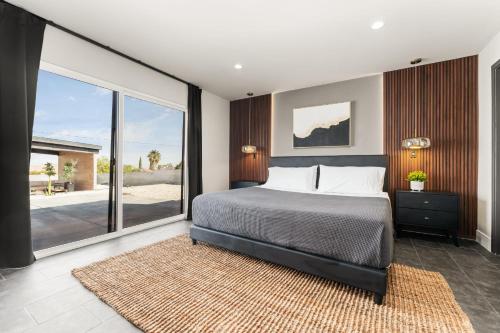 a bedroom with a bed and a large window at Desert Oasis in Joshua Tree