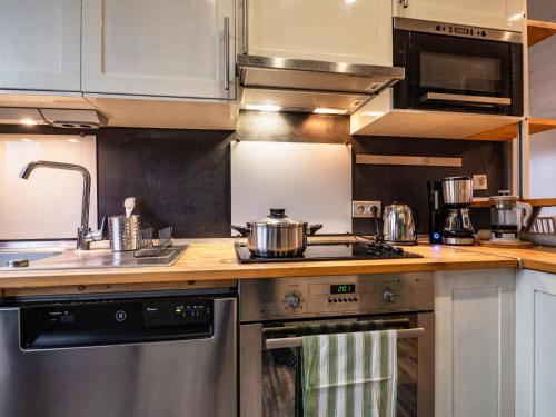 a kitchen with a stove and a counter top at Cosy apartment on Strasbourg Tramway line and Canal - Appartement confortable sur ligne tram Strasbourg et Canal in Bischheim