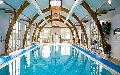 une grande piscine dans un grand bâtiment dans l'établissement Mobile home n°261 2chambres à 2 pas du lac !, à Gastes