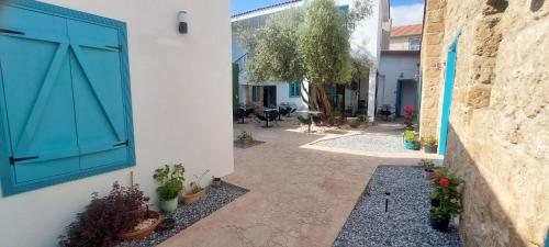 a courtyard with potted plants on the side of a building at Bella Casetta Guest House in Famagusta