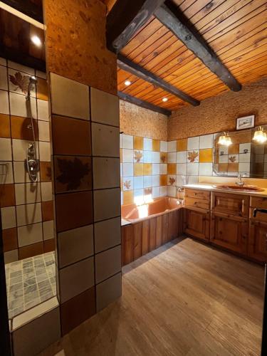 a large bathroom with a tub and a sink at Chalet Navillod in Tignes