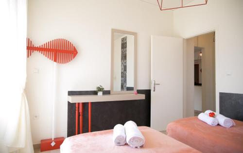 a bedroom with two beds with towels on them at Eos Villa in Imerovigli