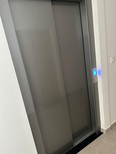 a glass elevator door in a building at Lea Lux Apartment in Grude