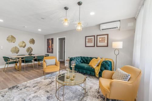 a living room with a couch and chairs and a table at House at Phipps in Atlanta