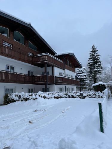 a building with snow in front of it at Haus Breitenfellner by AlpenTravel in Bad Hofgastein