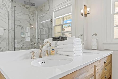 a white bathroom with a sink and a mirror at Magazine Manor W Pool in New Orleans