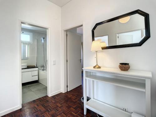 a white bathroom with a mirror and a sink at Casa Santa Rita by Atlantic Holiday in Funchal