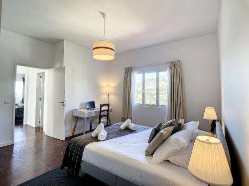 a bedroom with a large bed and a desk at Casa Santa Rita by Atlantic Holiday in Funchal