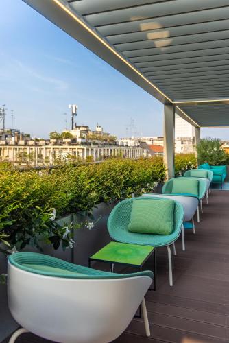 a row of chairs and tables on a balcony at Casa Baglioni Milan - The Leading Hotels of the World in Milan