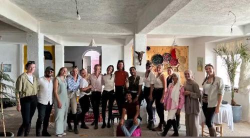 a group of people posing for a picture in a room at SurfcampLagrotte in Essaouira