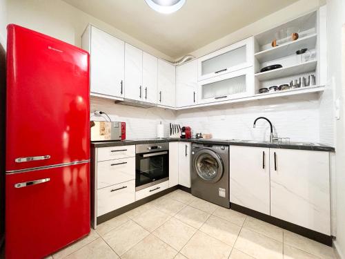 a kitchen with a red refrigerator and a dishwasher at Lucy's Home in Riglia