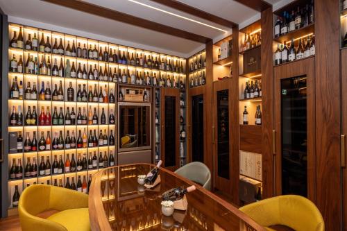 a wine tasting room with a wall of wine bottles at Casa Baglioni Milan - The Leading Hotels of the World in Milan