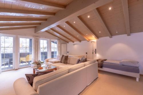 a living room with a couch and a table at Quality Hosts Arlberg - Hotel Bergheim in Sankt Anton am Arlberg
