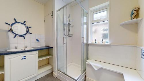 a bathroom with a shower and a sink at K Suites - Park Street in Grimsby