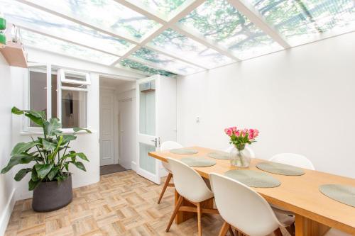 a dining room with a table and chairs and a skylight at 2 Bedroom Apartments in Covent Garden Sleeps 6 in London