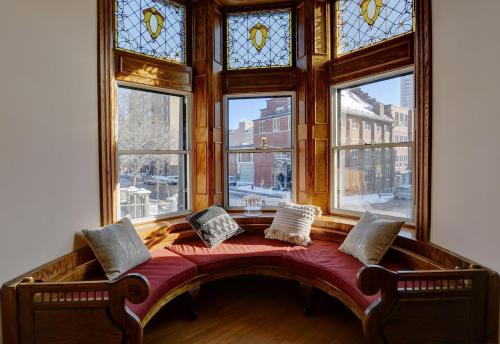 a bed in a room with a large window at Sublime Residence Downtown Montreal in Montréal