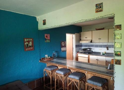 una cocina con barra con taburetes. en Finca La Esperanza, en Calima