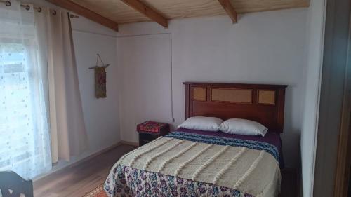 a bedroom with a bed with two pillows on it at Cerro Nevado in Puerto Tranquilo