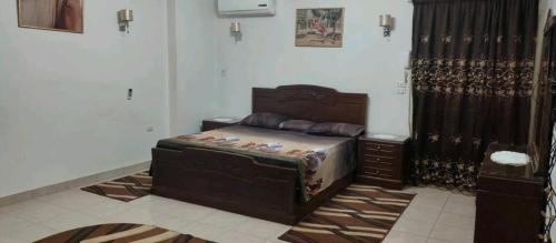 a bedroom with a bed and a dresser in it at شقه مفروشه مميزه in Cairo