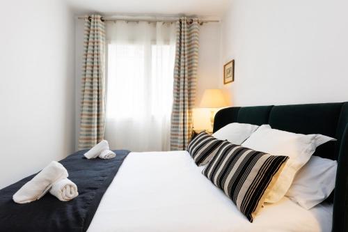 a bedroom with a bed with towels on it at Lodging Apartments Gracia 2 in Barcelona