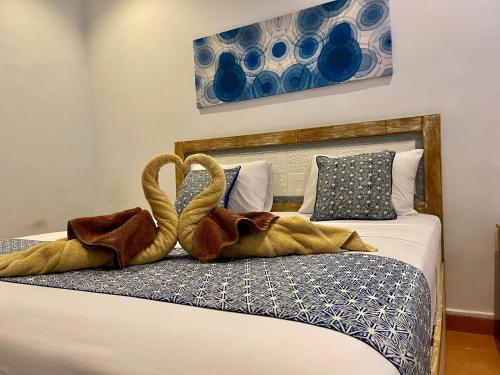 1 dormitorio con 2 toallas en una cama en Asri BALI SANUR Premier Suites, en Sanur