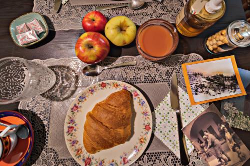 a table topped with a plate of bread and apples at Bed & Breakfast Gabriella EXILLES in Exilles