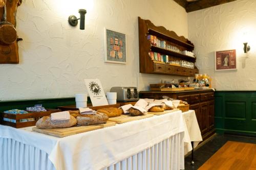 a bakery with a table with bread on it at Seilers Vintage Hotel & Spa in Kandersteg