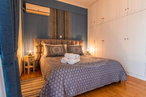 a bedroom with a bed with towels on it at Dantis Place in Nafplio vol.2 in Nafplio