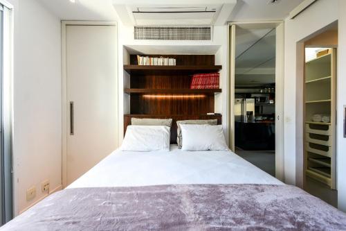 a bedroom with a bed with two white pillows at Çiragan Apartments by BnbHost in Sao Paulo