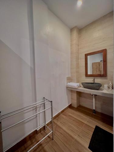 a bathroom with a sink and a mirror at Nay's Homestay in Canggu