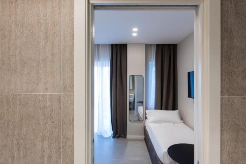 a hotel room with a bed and a mirror at Il Pumo - Apulian Rooms Bari Savoia in Bari