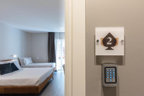 a room with a bed and a remote control at Il Pumo - Apulian Rooms Bari Savoia in Bari