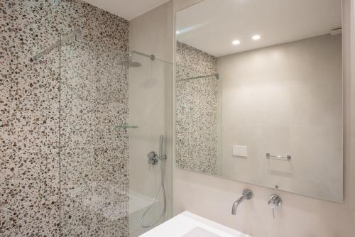 a bathroom with a shower and a sink and a mirror at Il Pumo - Apulian Rooms Bari Savoia in Bari