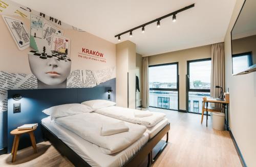 a bedroom with a large bed with a headboard at MEININGER Kraków Centrum in Krakow