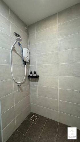a shower in a tiled bathroom with a shower head at Hot & Wild Couple Room@Cheras KL in Cheras
