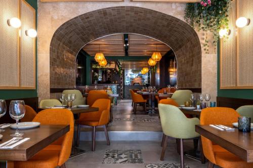 a restaurant with tables and chairs and a brick wall at Studio 32 - Apartment & kitchenette at the new Olo living in Paceville