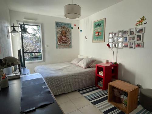 a bedroom with a bed and a desk and a table at T3 de 68m2 avec jardin, à 5mn gare et centre ville in Nantes