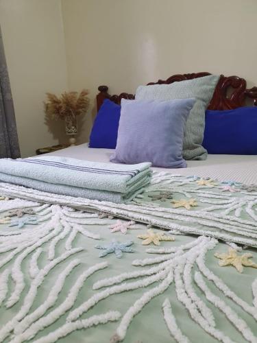 a bed with two pillows on top of it at Chez Stef Taghazout in Taghazout