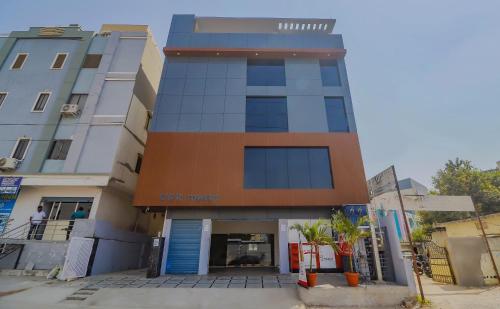 a tall building with a car house at Super OYO Collection O 78286 White Ridge Near LB Nagar in Surūrnagar