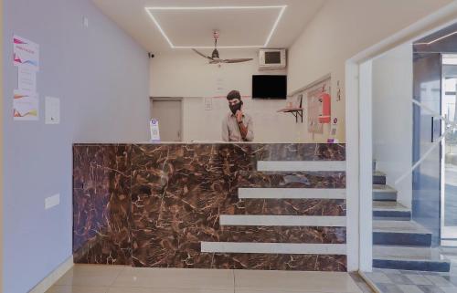 a person standing on a staircase in a room at Super OYO Collection O 78286 White Ridge Near LB Nagar in Surūrnagar