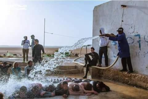a group of people playing in a water fountain at Appartements de luxe à Al Mahdi in Dakhla