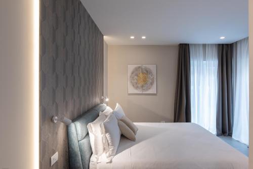 a bedroom with a large bed and a wall at Il Pumo - Apulian Rooms Bari Savoia in Bari