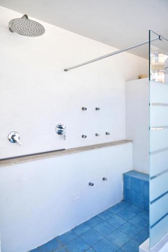 a bathroom with a shower and a blue tile floor at Madama B&B in Gaeta