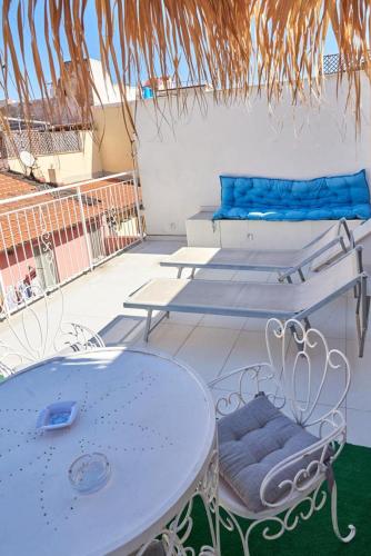 a white table and chairs on a patio at Madama B&B in Gaeta