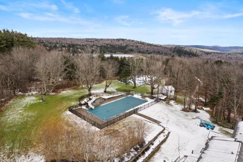 an aerial view of a swimming pool in a field at Brook Bound Inn in Wilmington