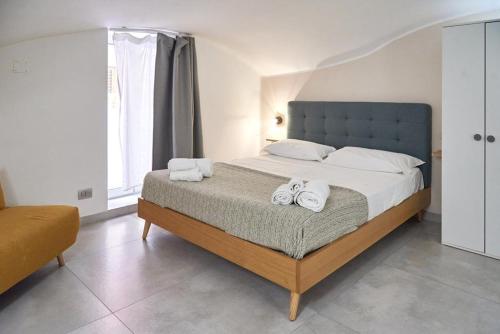 a bedroom with a large bed with towels on it at Madama B&B in Gaeta