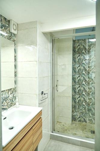 a bathroom with a shower and a sink and a glass shower door at Madama B&B in Gaeta